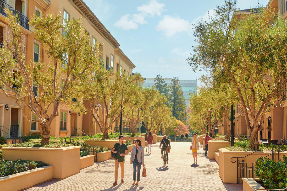 People walking and biking on path of Crescent Village apartment