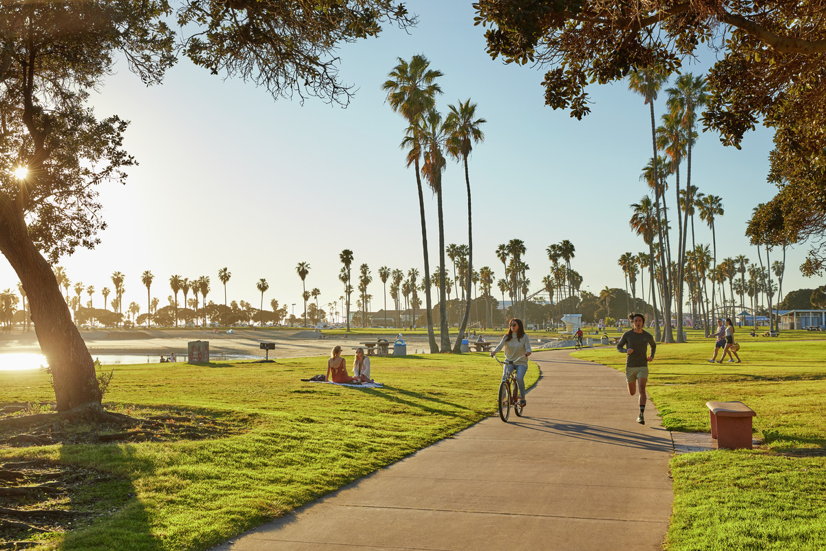 People at the park biking and running