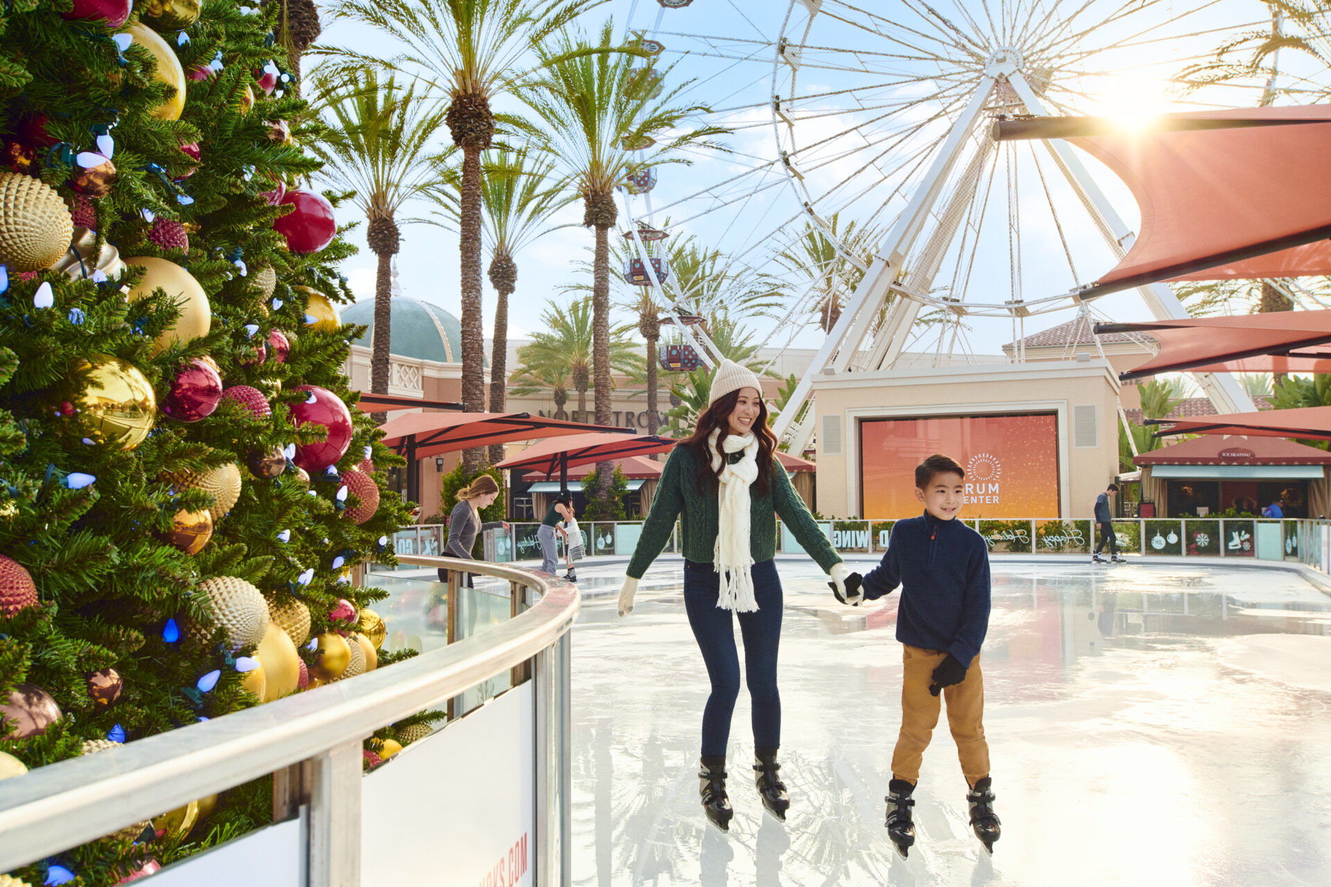 Mother and son on outdoor skating rink