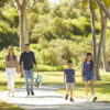 Family of four walking though William Mason Park