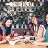 View of group of friends sitting at Bare Bottle